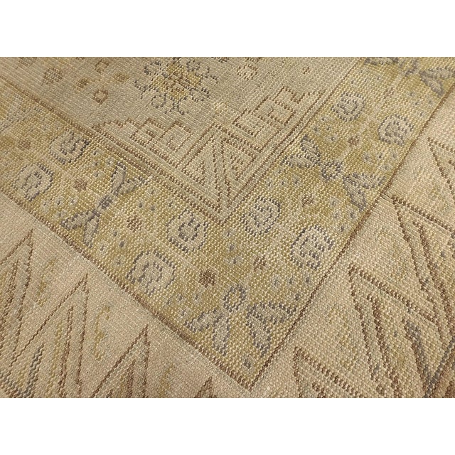 Three large round medallions on a soft blue field. Wide border with geometric pattern elements. Wool pile, shaved low, on...