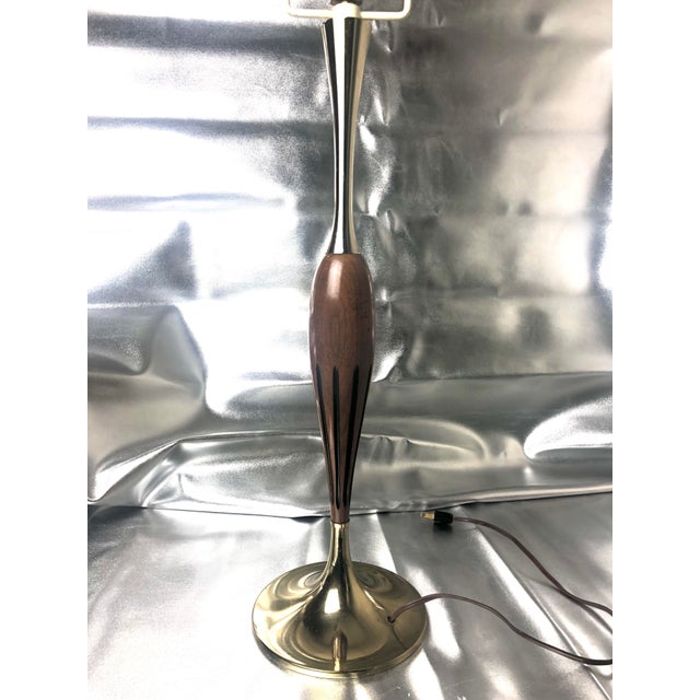 Vintage mid century lamp with a fantastic shape and great brass tulip base and neck. It has a long original cord that is...