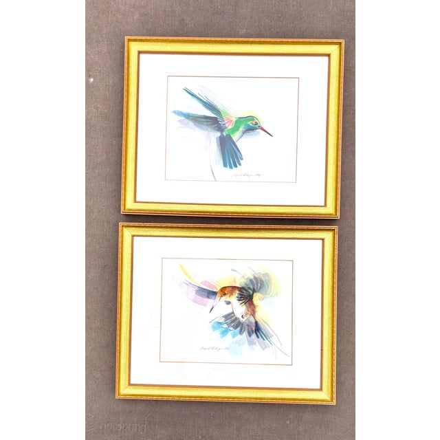Gorgeous set of 2 framed original watercolors of hummingbirds. They are both signed by the artist, Alfred Phillips 1994....