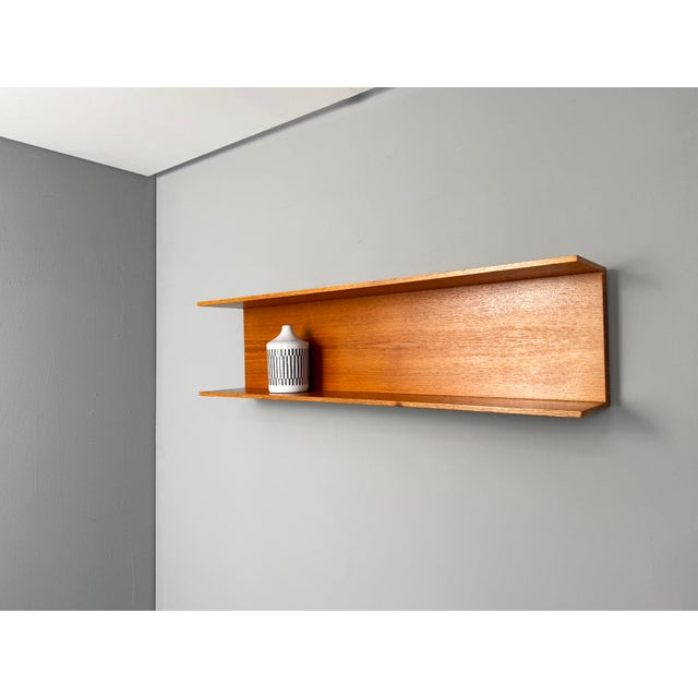 Teak Wall Shelf by Walter Wirz for Wilhelm Renz, 1960s, in Very Good conditions. Designed 1960 to 1969 This piece has an...
