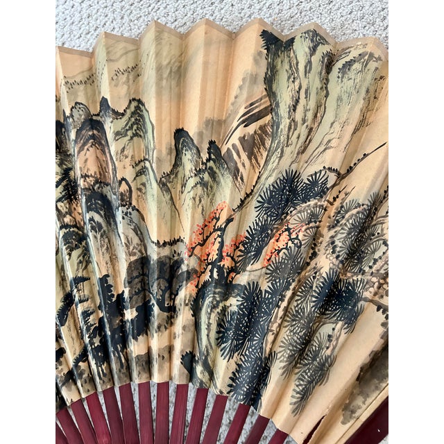 Striking oversized Japanese folding fan dating to the 1980s, featuring a mountainous landscape rendered in expressive...