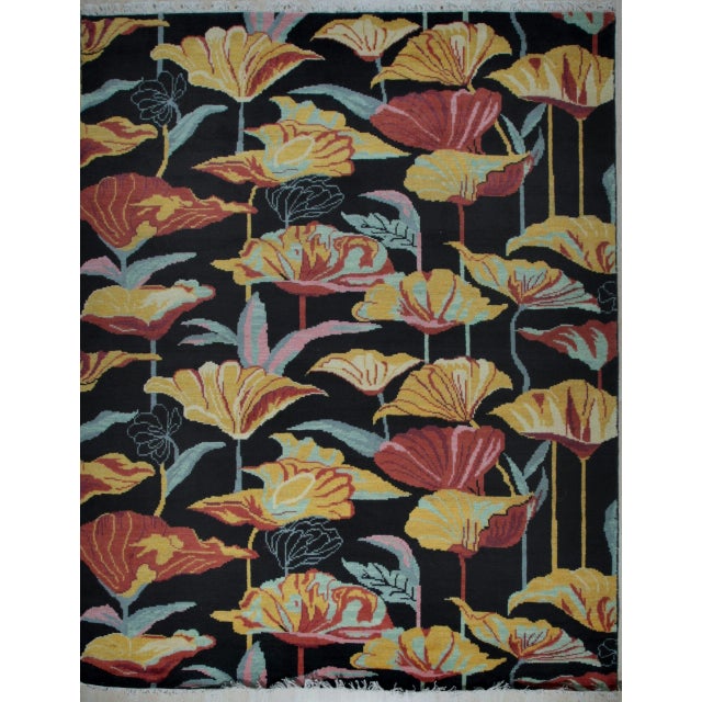 A hand-knotted wool rug, made in India and measuring 8' x 10'. Geometric drawing - repeating motifs held inside strong...