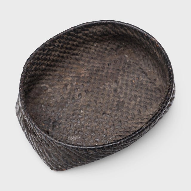This small woven tray from the early 20th century celebrates the beautiful simplicity of a hand-woven object. The dish is...