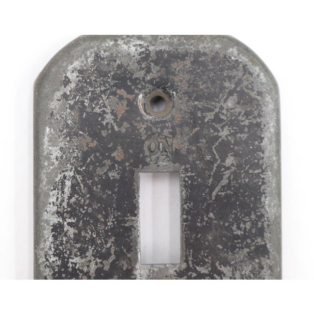 Standard size distressed black steel toggle light switch cover. The original mounting screws are not available. Good...