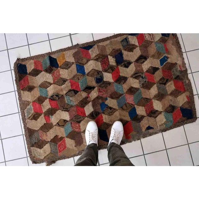 Handmade antique American Hooked rug in geometric design. The rug is from the end of 19th century. The rug has some old...