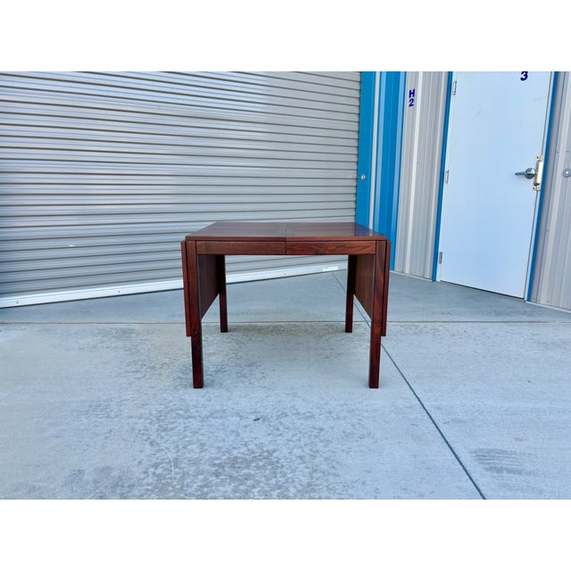 Danish Modern extended rosewood dining table was designed and manufactured by Vejle Stole & Møbelfabrik in Denmark in the...