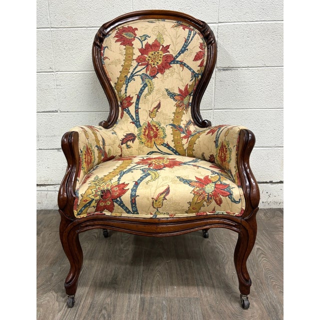 This is a gorgeous antique Victorian Rococo Revival walnut balloon-back armchair or parlor chair featuring a dramatic...