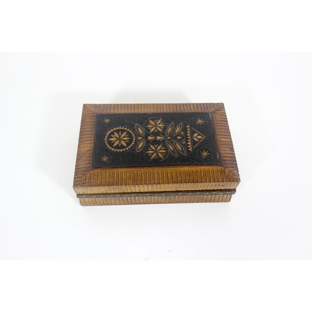 Vintage folk art hand carved wood box with a hinged lid. Inside are two compartments and a mirror that folds out and props...