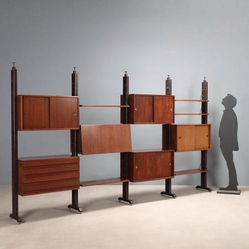 Vintage four-bay bookcase made of wood with exotic wood veneer and brass ends, features shelves and storage compartments...