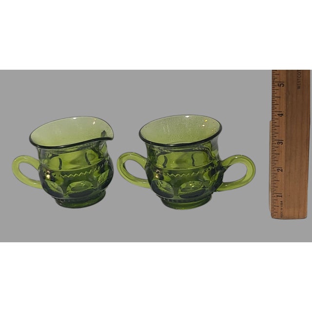 Elevate your table setting with this Vintage Green Indiana Glass Thumbprint Creamer & Sugar Set, a timeless addition to...