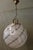 Large round Murano glass pendant light. Vintage 1970s. Decorated with black stripes that follow the shape of the light....