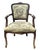 A charming vintage French-style armchair featuring a carved wood frame, gently curved cabriole legs, and upholstered...