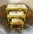 Elegant set of three French-style nesting tables featuring sophisticated gold frames accented with luxurious gold leaf...