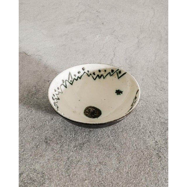 A very rare French mid century ceramic bowl in a black enammel and white green painted inner decor by Pablo Picasso...