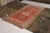 Hand knotted in wool originating from East Turkestan circa 1950-1960, this mid-century piece connotes a vintage Khotan rug...