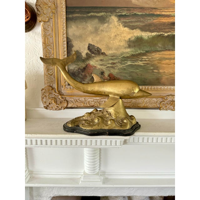 …a rare and unique piece! a wonderful mcm brass sculpture featuring a dolphin perched on the most amazing swirly waves,...