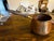 Antique copper poring pot with a wooden handle and spout. Made in Holland. Lovely to add to your kitchen collection of...