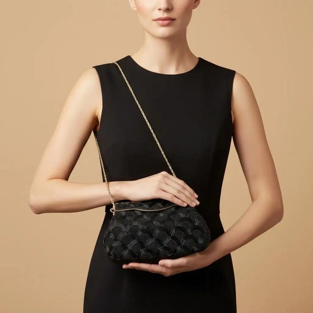 This exquisite 1940s French evening bag is a stunning example of mid-century craftsmanship, featuring an intricate...