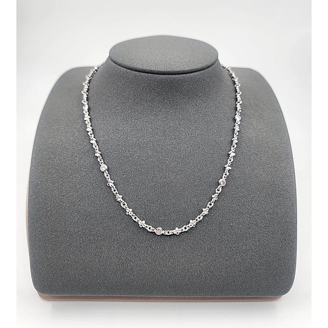 This necklace showcases a refined blend of elegance and craftsmanship. Featuring 8 natural, round-cut white diamonds...