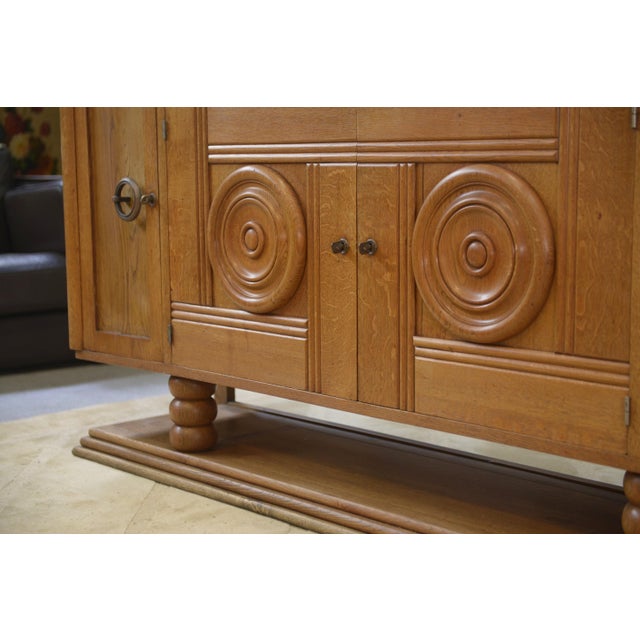 Oak Buffet in the style of Charles Dudouyt, 1930s, in Very Good conditions. Designed 1920 to 1949 This piece is designed...