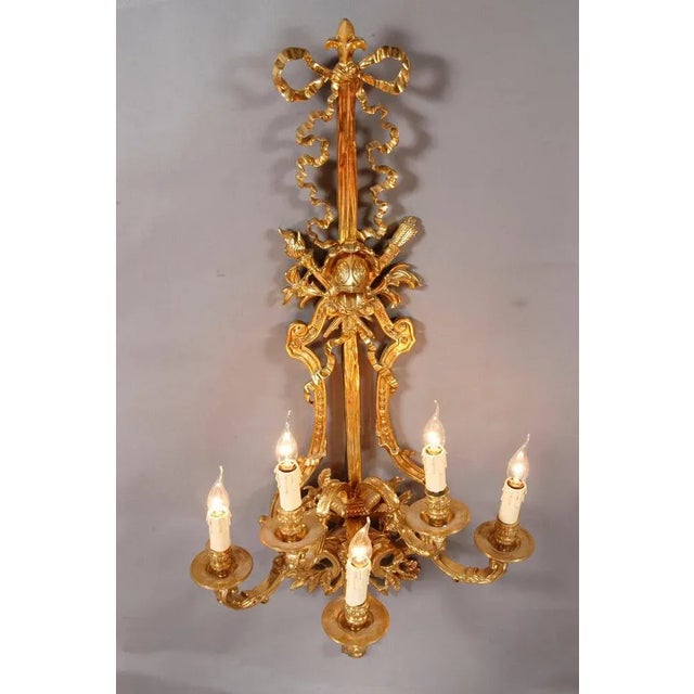 Monumental applique in Louis XVI style. Five-flamed light- corpus. Engraved Bronze. Flat wall shield from a relief of...