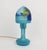 "Mushroom" table lamp made up of two parts in blue tinted glass, wooded landscape decoration on the upper part. French...