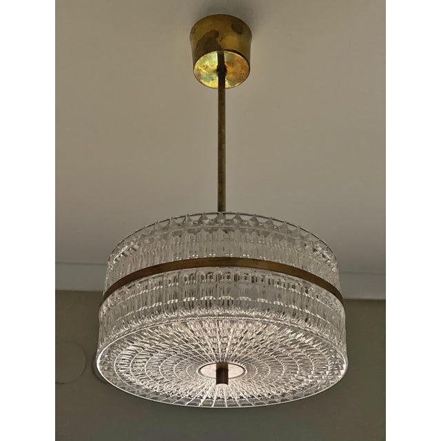 Swedish Glass Pendant Light with decorative Brass Outer Band, design by Swedish Orrefors. 1960s. Great vintage condition,...