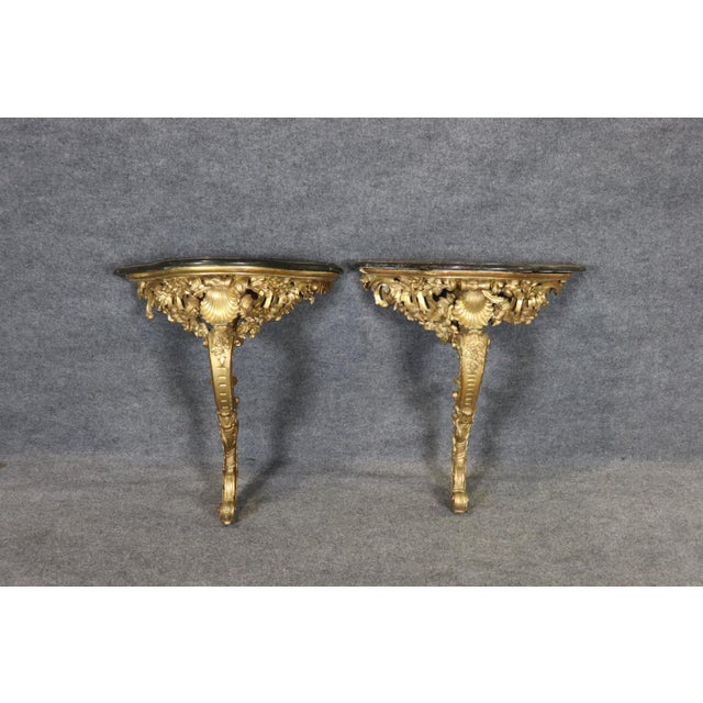 This exquisite pair of French Louis XV wall-mounted consoles represents the height of Rococo artistry, combining dramatic...