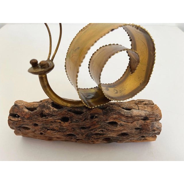 Adorable 1970s snail sculpture hand crafted of torch cut metal in shades of copper and gold with a flexible kinetic ribbon...