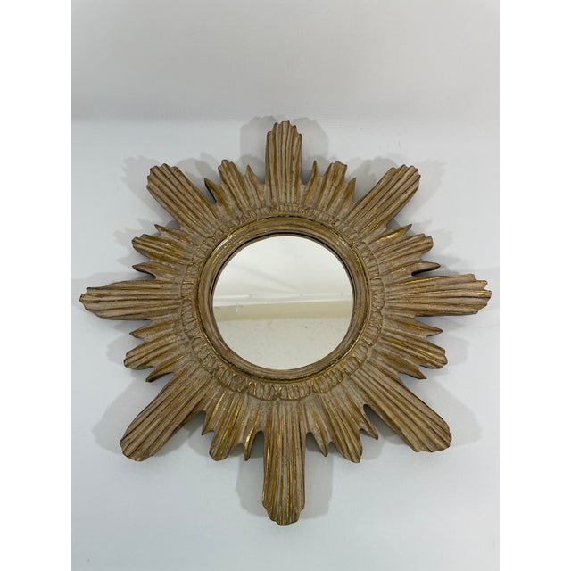 A stunning 16.5" Italian style Gilded Sunburst Wall Mirror from the 1960s. This Mid Century Modern wood mirror features...