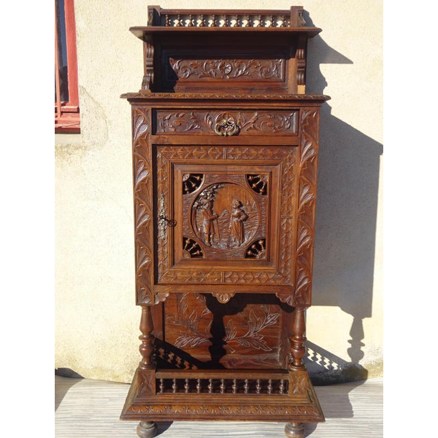 Small storage cabinet, finely hand-carved French. Originating from Brittany, it depicts a scene of daily life in bas-...