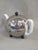 A charming and functional vintage 1930s or 1940s Art Deco creamware porcelain teapot which sits inside of a clever custom...