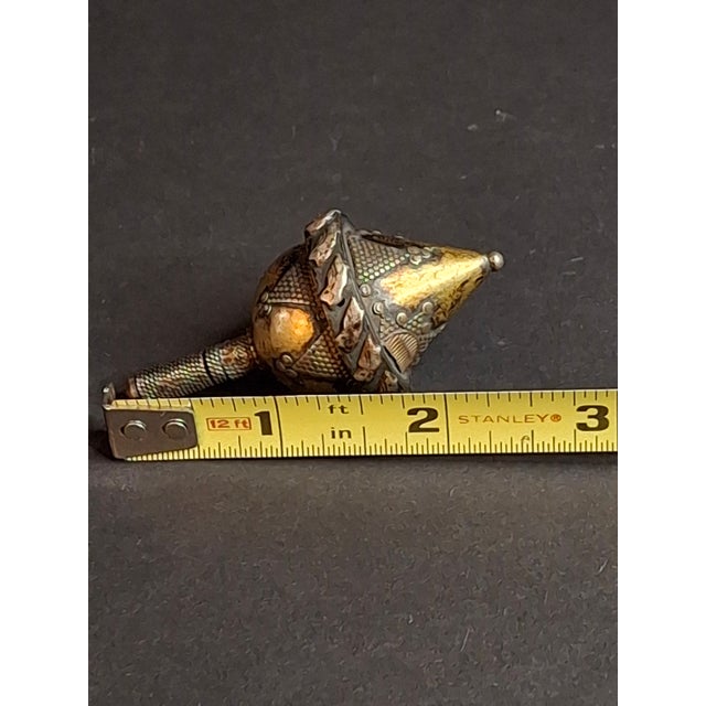 Curator’s Note: This masterfully crafted object exists at the intersection of historical toy and fine metalwork. Its...