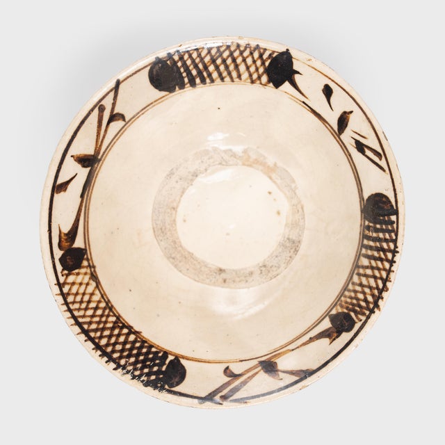 This antique Chinese rice bowl dates to the late Ming dynasty (13681644) and is beautifully glazed in neutral earth-tones...