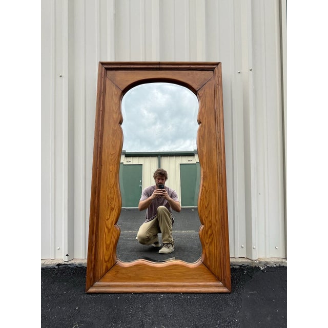 A terrific piece of antique decor. This full length antique mirror hails from the early 1900's with aged oak and hand-cut...