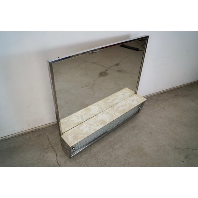 Vintage 1950's Mid Century Modern medicine cabinet for sale. It has a vanity mirror with a chrome frame, and two sliding...