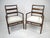 A pair of matching sophisticated dark mahogany ladder backed armchairs with cream upholstered fabric seats. This well-...