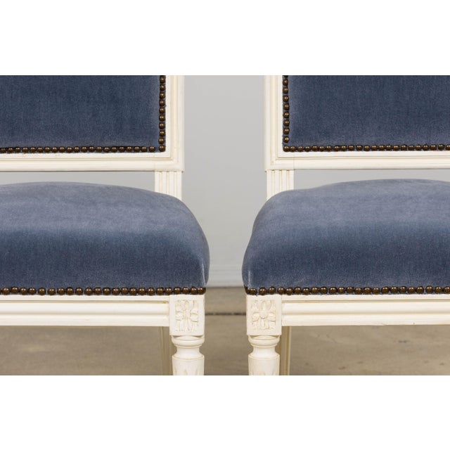 A refined pair of French Louis XVI style side chairs sourced in Paris, dating to the early 20th century. Each chair...