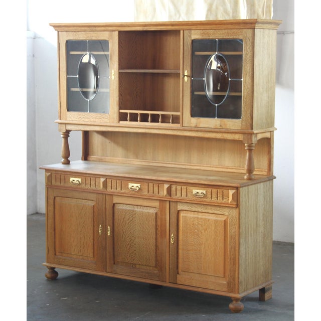 Elevate your dining space with this exceptional Mid-Century Modern Light Oak Display Cabinet / China, a true testament to...