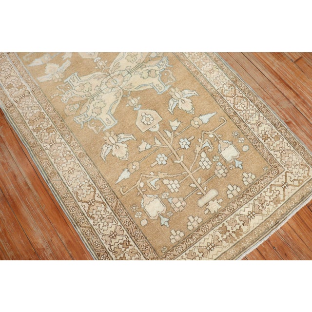 mid-20th century Persian rug in light brown, accents in white and light blue Measures: 3'5" x 6'5".