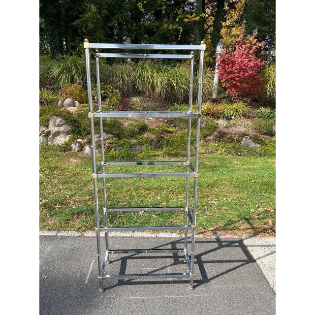 Mid Century Chrome Etagere in the style of Maison Jansen. Two toned design with of chrome with brass trim. Five shelf...