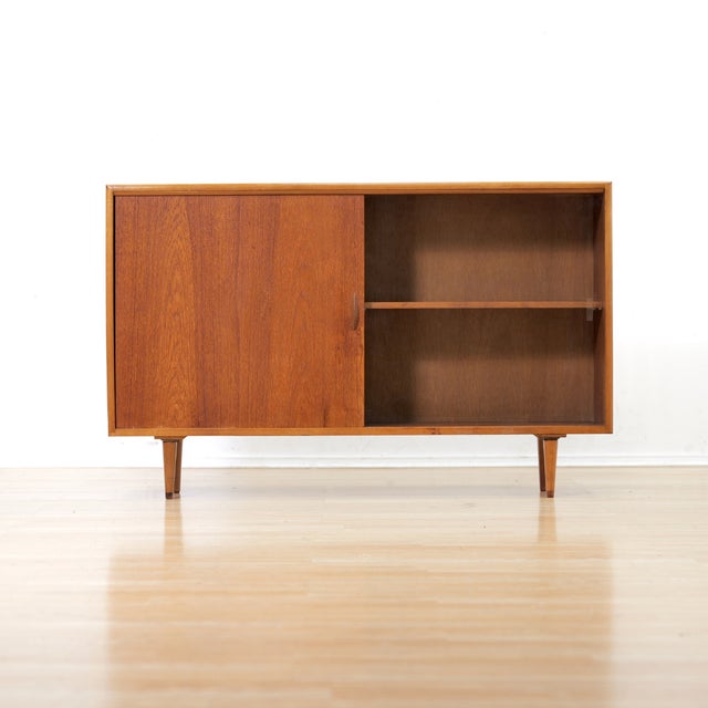 This vintage mid-century china cabinet was produced in England during the 1960s. Made from teak, this minimalist cabinet...