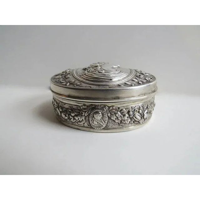 Silver Hanau box with man's profile. Interior gold wash. From the middle to the end of the nineteenth century copies of...