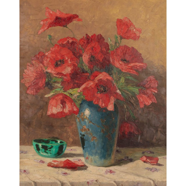 An Impressionist style floral still life painting depicting a bouquet of red poppies in a blue vase with a small green...