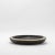 The Lily Bowl in black oak with bronze patina brass details by R&Y Augousti is a stunning embodiment of organic elegance...
