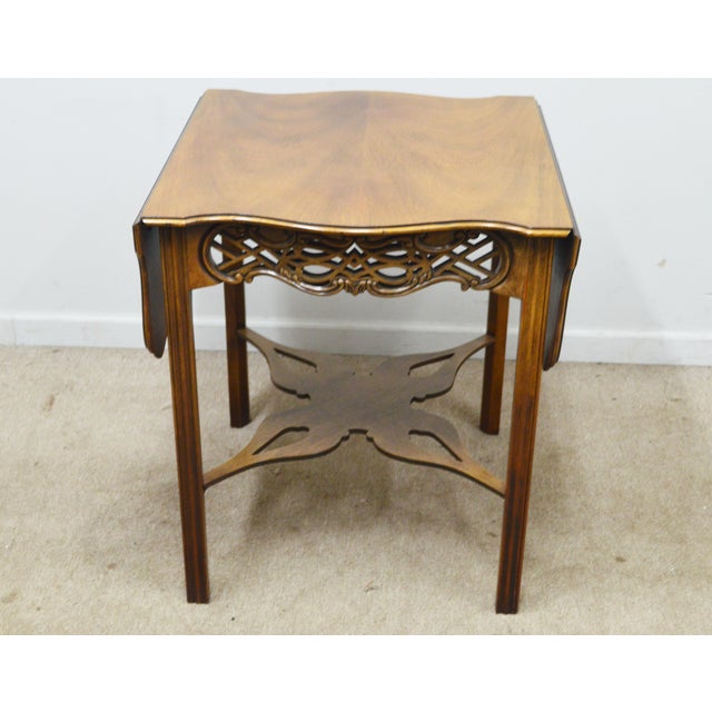 Side Table by Baker. Store item # 526. It features carved wood end extendable (up to 42.5") sides.