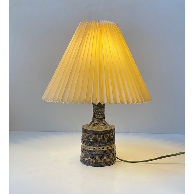 Stoneware Table Light decorated with earthy glazes and an abstract center motif . Design by Jette Hellerøe and...