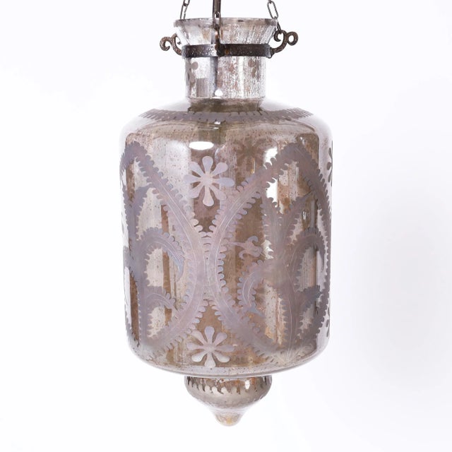 Standout pair of exotic lanterns hand blown in classic form, hanging from hammered metal hardware featuring etched floral...