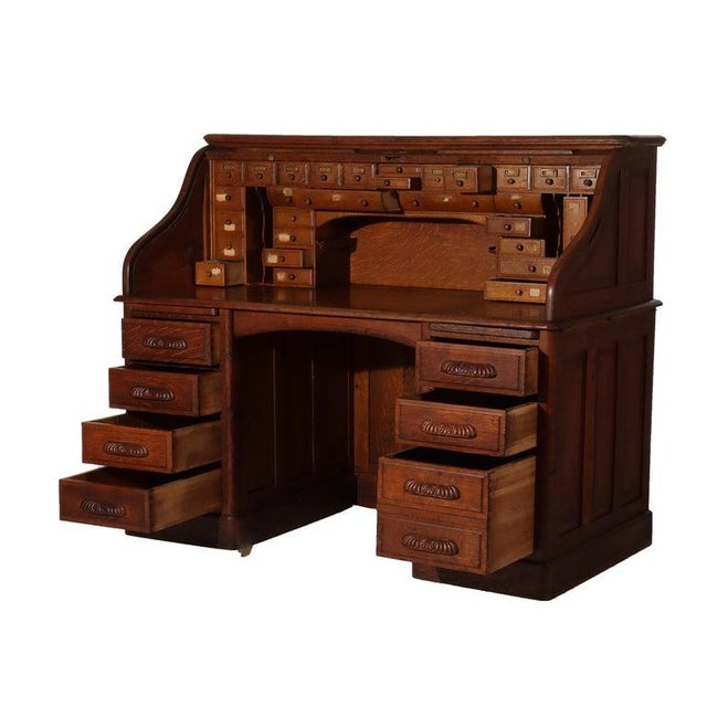 Antique Oak S Roll Top Desk with Full Interior Unsigned C1900 Measures - 50.25"H x 60.25"W x 32"D This oak roll top desk,...