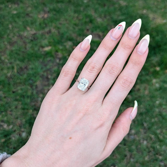 5Ct lab diamond ring enhanced with sapphire accents and a shimmering lab diamond halo. Crafted in solid 14K gold, this...